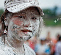 woman-with-flour-on-the-face-during-pii-mai-lao-new-year-celebration-D93NG8.jpg