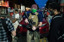 30227164-8475061-A_volunteer_works_security_at_an_entrance_to_the_CHOP_zone_on_Ju-a-19_1593543...jpg
