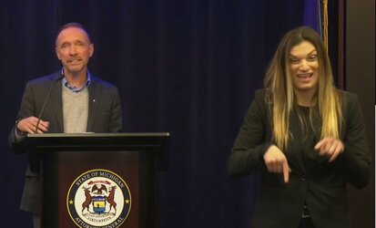 sign language interpreter michigan 202 pointing down.jpg