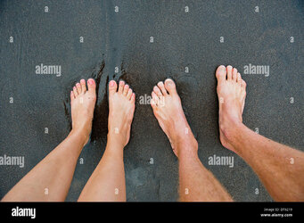pairs-of-male-and-female-feet-on-black-sand-DT6219.jpg