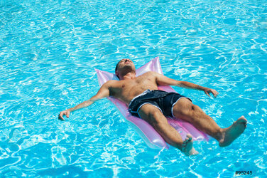 young-man-relaxing-on-swimming-95245.jpg