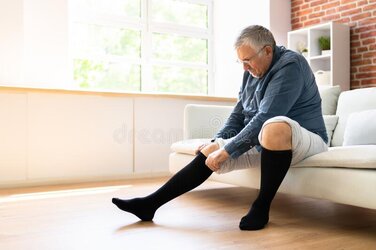man-putting-medical-compression-stockings-legs-man-putting-medical-compression-stockings-24919...jpg