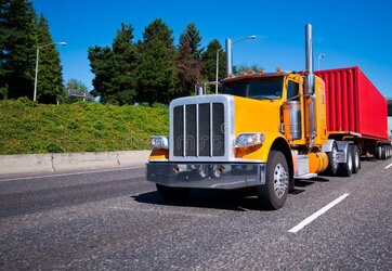 classic-bonnet-legendary-popular-bright-orange-big-rig-semi-truck-high-exhaust-pipes-chrome-bu...jpg