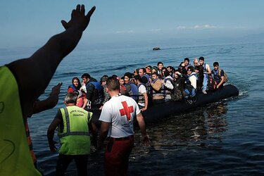 a-group-of-migrants-land-on-a-beach-with-a-raft-from-turkey-onto-the-island-of-lesbos-on.jpg