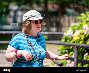 outdoor-portrait-of-a-40-yo-woman-with-the-down-syndrome-wearing-sunglasses-and-a-hat-tienen-b...jpg