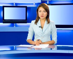 female-news-anchor-blue-set-and-desk.jpg
