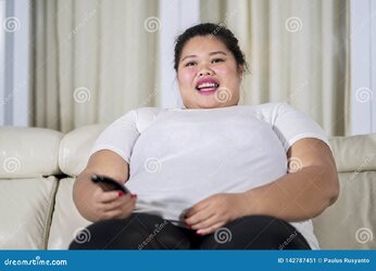 overweight-woman-watching-tv-living-room-happy-overweight-woman-sitting-sofa-watching-tv-smili...jpg