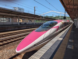 Pink and white Shinkansen train