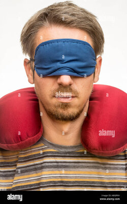 bearded-man-with-sleeping-mask-and-red-travel-pillow-on-white-background-H6GPXH-2902102212.jpg