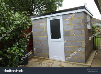 stock-photo-construction-of-a-garden-shed-made-from-concrete-blocks-704823547.jpg