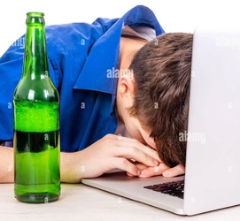 man-with-a-beer-bottle-sleep-on-the-laptop-computer-isolated-on-the-white-background-closeup-2...jpg