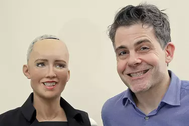 A creepy robot and Sophia.