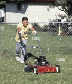 austin-texas-usa1988-hispanic-boy-13-mowing-lawn-with-gas-powered-mower-mr-rr-0092-bob-daemmri...jpg