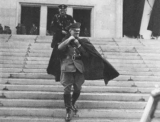 Adolf_Hitler_leaving_the_Nuremberg_party_congress_and_wearing_a_cape_Germany_in_1936-768x588-...webp