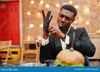 wearing-gloves-food-respectable-young-african-american-man-black-suit-sitting-restaurant-tast...webp