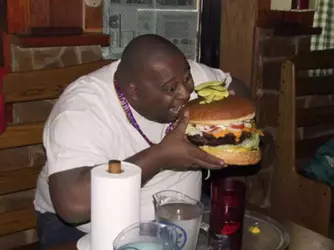 fat-guy-eating-giant-hamburger.webp