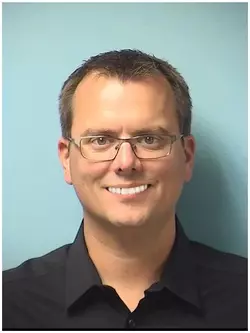 mugshot_indian_tech_guy.webp